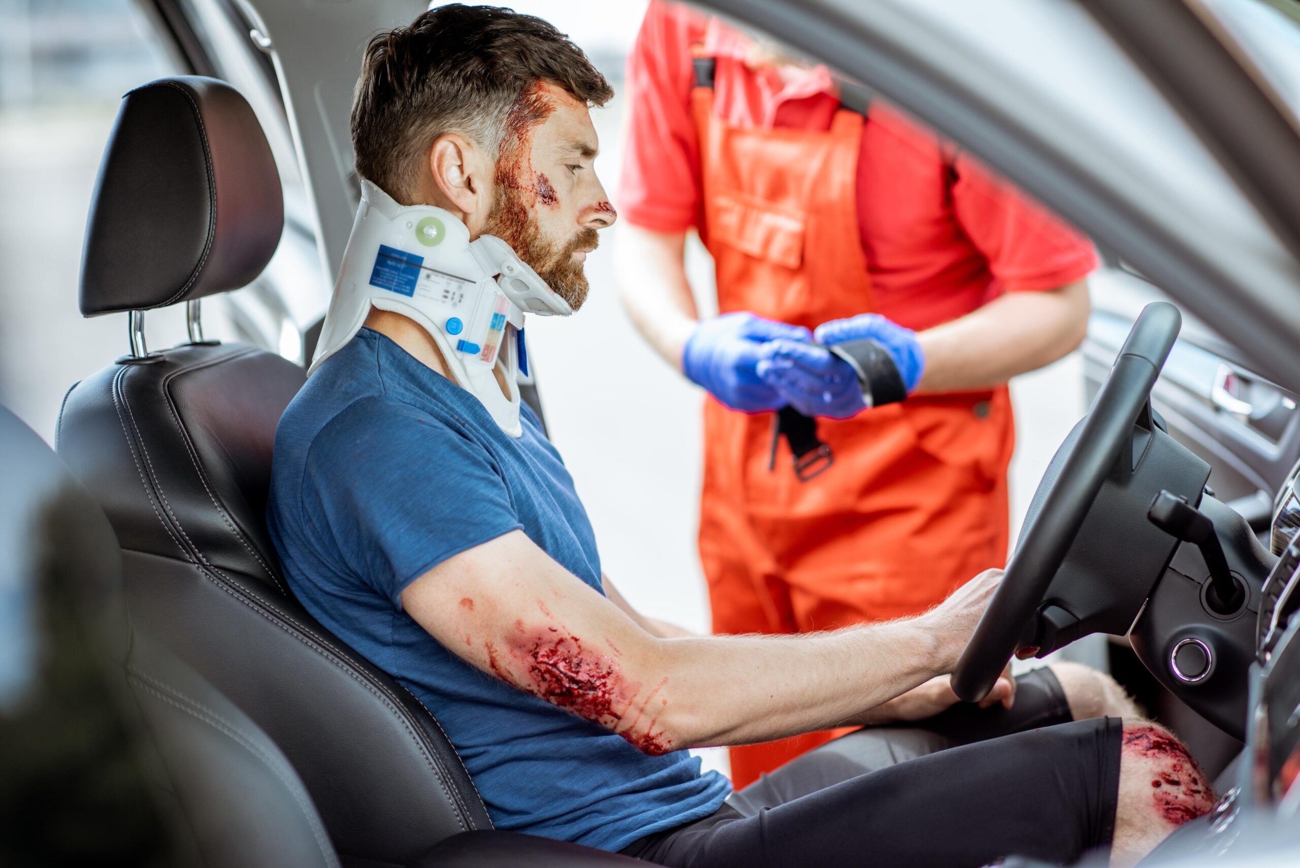 Injured man sitting in car after accident in Los Angeles