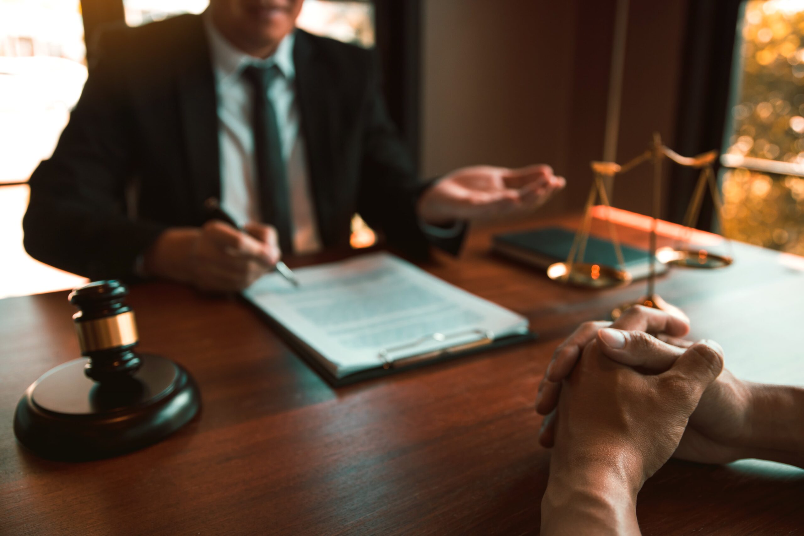 Lawyer and client discussing truck accident legal matters with a gavel.
